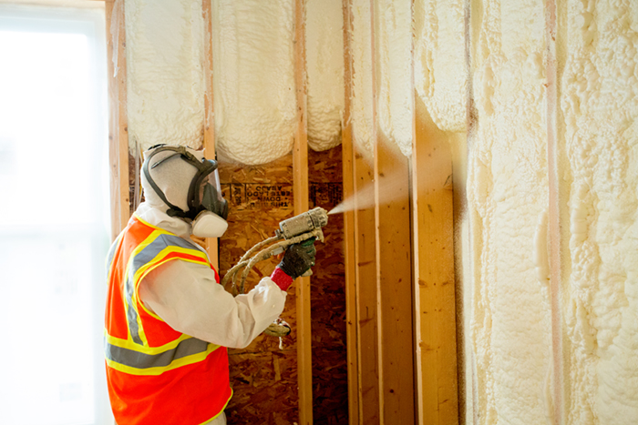 A Leading Edge Insulation Services employee installs spray foam insulation at a new construction project. Spray foam can be used to fill gaps and stop air leaks in many areas of both new and existing homes or buildings. Courtesy Leading Edge Insulation Services